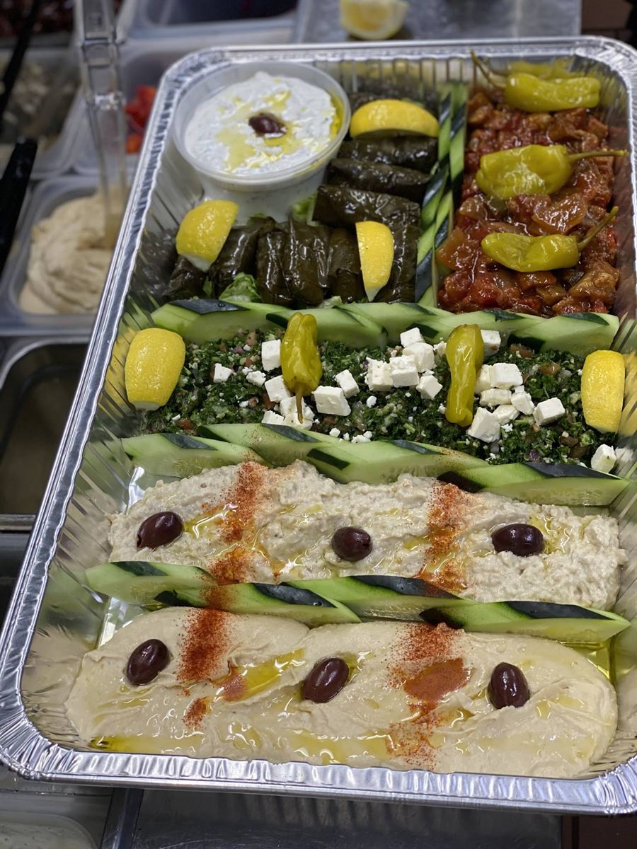 Catering meze tray — tzatziki, dolma, tabbouleh, baba ghanoush and hummus